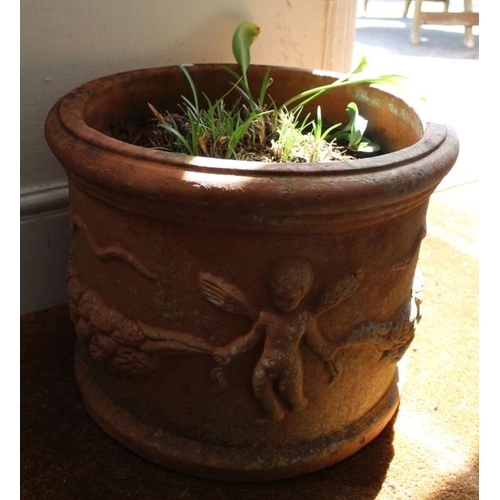 300 - A large terracotta circular planter, decorated with putti & swags, 42cm internal diameter