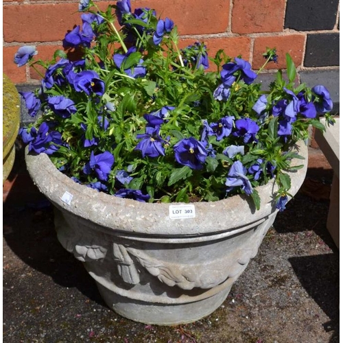 303 - A cast concrete swag decorated garden planter, containing purple pansies