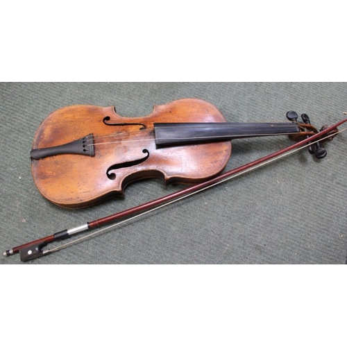 70 - An unnamed antique violin having one piece back with a mid 20th century unnamed bow i the remains of... 