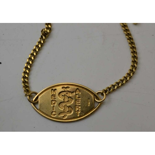 102 - A 9ct gold medic alert pendant, a 9ct gold medic alert wrist pendant on yellow metal chain, one othe... 