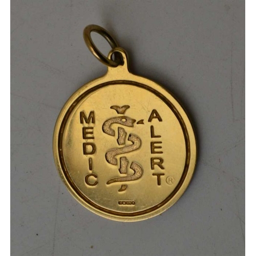 102 - A 9ct gold medic alert pendant, a 9ct gold medic alert wrist pendant on yellow metal chain, one othe... 