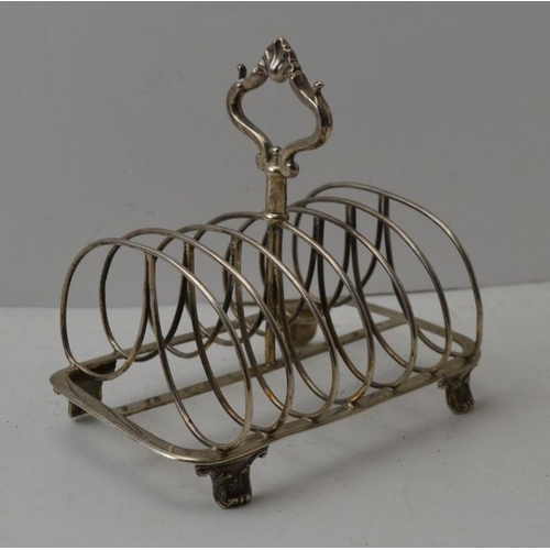 11 - Robinson, Edkins and Aston, a Victorian silver toast rack, decorative central handle, raised on anth... 