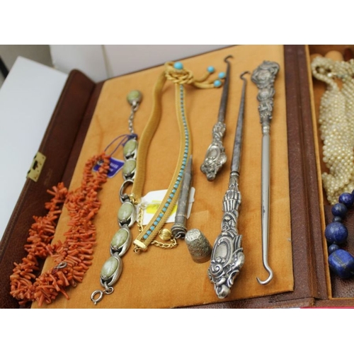 121 - A large quantity of costume jewellery, to include watches, a green leather jewellery case, etc.