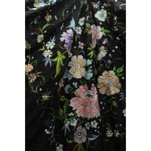 148 - A late 19th century shawl, the black ground embroidered all over with flowers in multi-colours, with... 