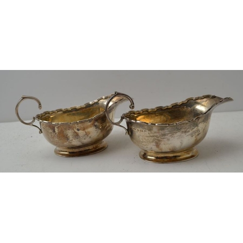 17 - Adie Brothers, a pair of Georgian design silver sauceboats, having fancy rim and 