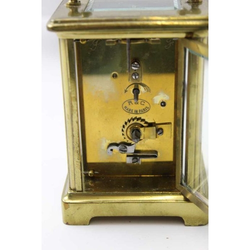 203 - A late 19th century French brass framed carriage clock, the white enamel dial, with Roman numerals, ... 