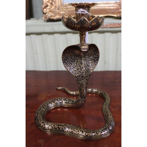 223 - A pair of Indian brass Cobra form candle holders, 14cm high and a single larger one, 21cm high