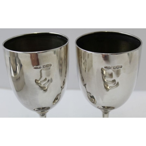 23 - James Dixon & Sons, a plain silver tapering tankard, Sheffield 1931, together with two silver goblet... 