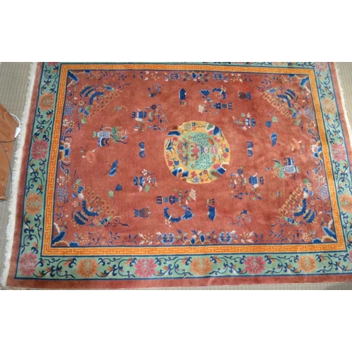 241 - A large Chinese carpet, brown ground with vase and flow decoration in colours. The central fields co... 