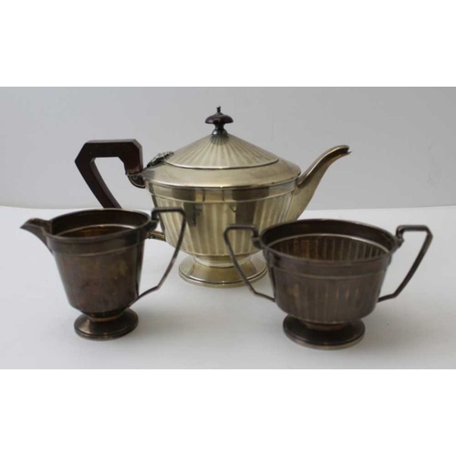 27 - Adie Brothers, a three-piece silver tea set comprising; teapot, sugar, and milk jug, Birmingham 1931... 