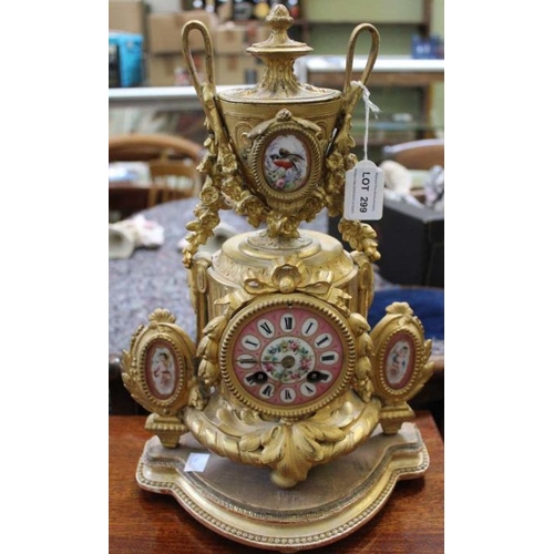 299 - A 19th century French Ormolu mantle clock in the form of a vase on a plinth having painted porcelain... 