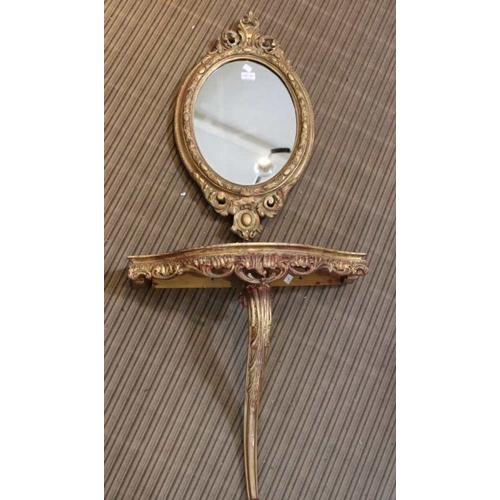 305 - A fancy gilt framed oval plain plate wall mirror, together with a gilded mono-pedic console table, 5... 