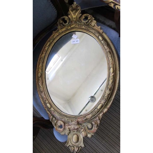 305 - A fancy gilt framed oval plain plate wall mirror, together with a gilded mono-pedic console table, 5... 