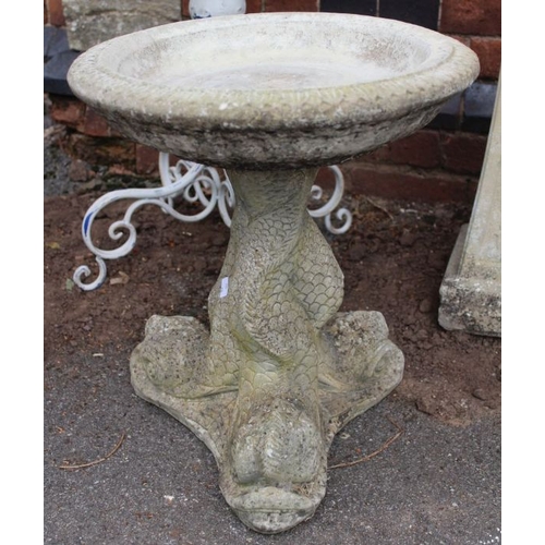 358 - A small stone bird bath raised on ornate fish design support