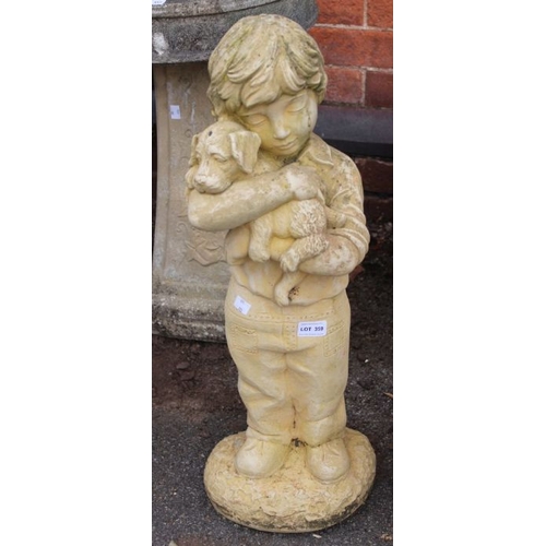 359 - A small statue of a boy holding a puppy