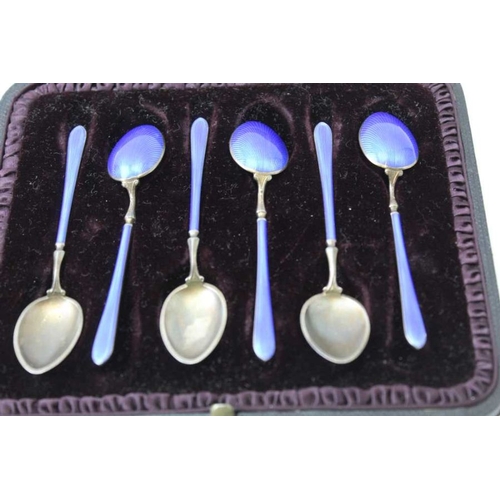 38 - A set of six silver gilt and blue enamel coffee spoons, in vendors leather case