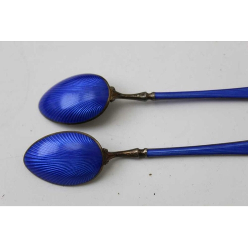 38 - A set of six silver gilt and blue enamel coffee spoons, in vendors leather case