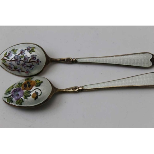 39 - A cased set of six silver gilt and white enamel coffee spoons, the reverse of each bowl floral decor... 