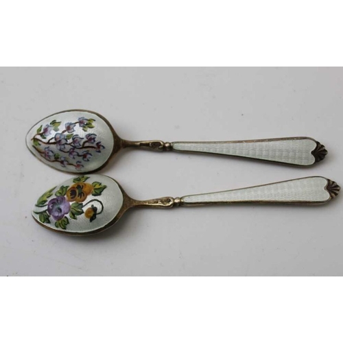 39 - A cased set of six silver gilt and white enamel coffee spoons, the reverse of each bowl floral decor... 