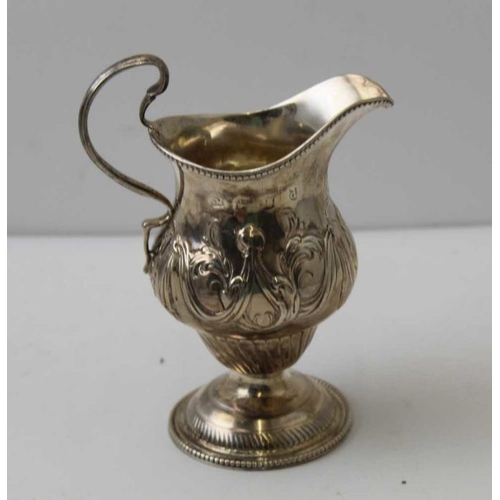 40 - Samuel Meriton, A George III silver cream jug, with repousse swag decoration, raised on circular dom... 