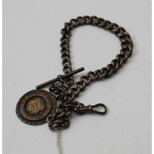 50 - A silver watch chain, with T bar and clip, mounted with a silver and enamel fob, dated 1934, combine... 