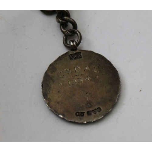 50 - A silver watch chain, with T bar and clip, mounted with a silver and enamel fob, dated 1934, combine... 
