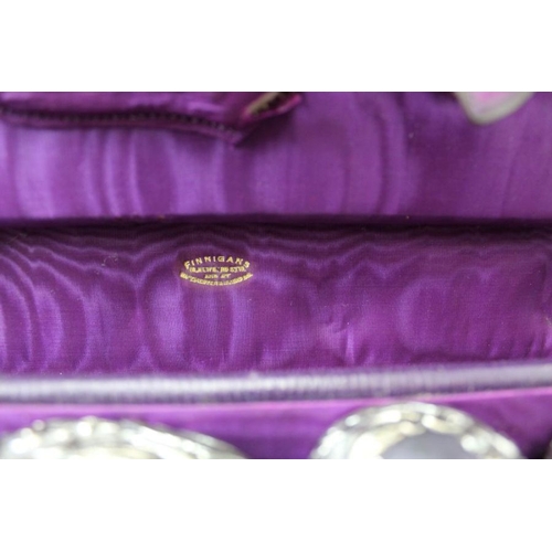 62 - An Edwardian Finnigan's of New Bond St. London & Manchester, purple leather vanity case, partly fitt... 