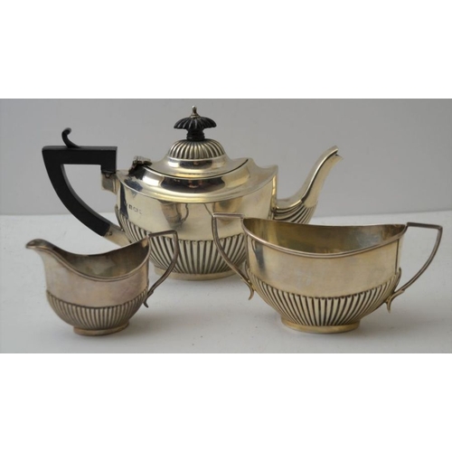 7 - An Edwardian silver bachelor tea set, of Georgian design, comprising a tea pot, silver sugar bowl an... 