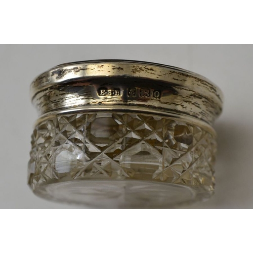 87 - A collection of silver mounted glass dressing table jars, various hallmarks