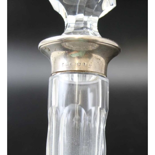 95 - A cut glass decanter with silver collar and a silver whisky label