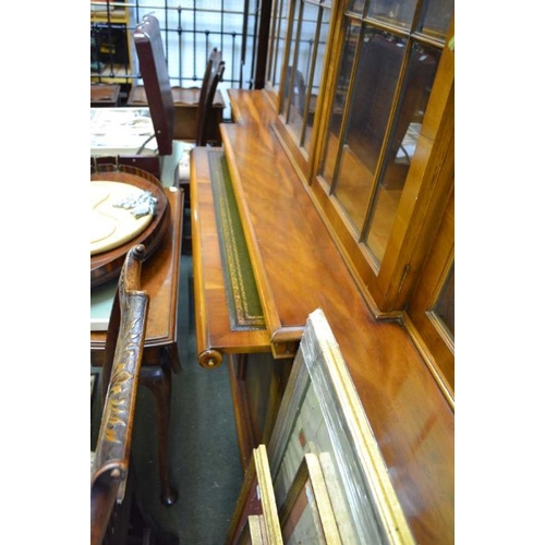 118 - A well made quality reproduction Yew wood break front bookcase fitted with a slide and part fitted c... 