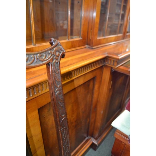 118 - A well made quality reproduction Yew wood break front bookcase fitted with a slide and part fitted c... 