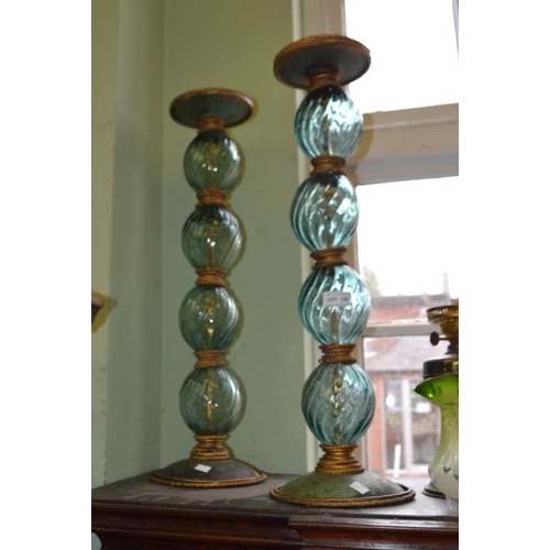 126 - A pair of fancy glass and metal tall candle sticks