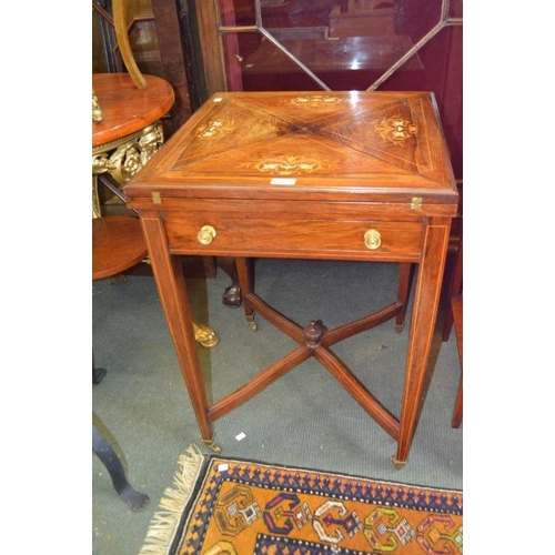 128 - A late 19th early 20th century inlaid rosewood envelope card table with single drawer four plain tap... 