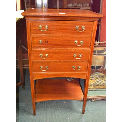 130 - A first quarter 20th century mahogany four drawer music cabinet, on four slender legs, united by an ... 