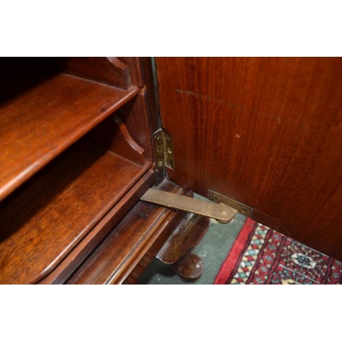 136 - A 20th century Waring & Gillow mahogany two door music cabinet, on short cabriole legs