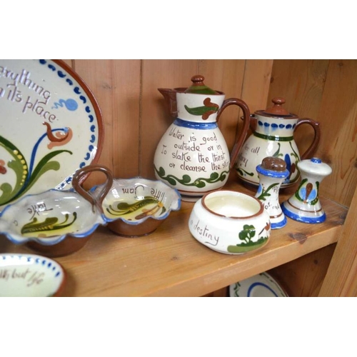 147 - A large selection of Torquay Pottery Motto ware