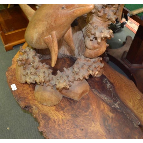 187 - A carved wooden free standing sculpture of a family of dolphins