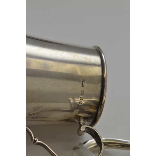 261 - Josiah Williams & Co. A silver flared body tankard, London 1939, together with a baluster form silve... 