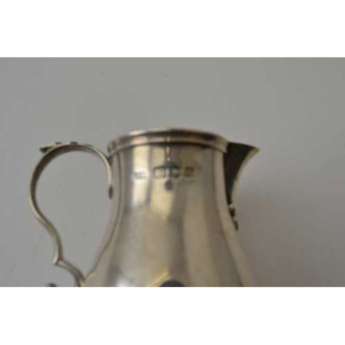 262 - Alfred Ernest Neighbour, A Georgian design silver baluster cream jug, with sparrow beak, London 1938... 