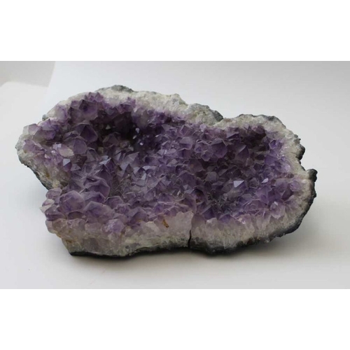 293 - A large amethyst geode, 32cm x 22cm