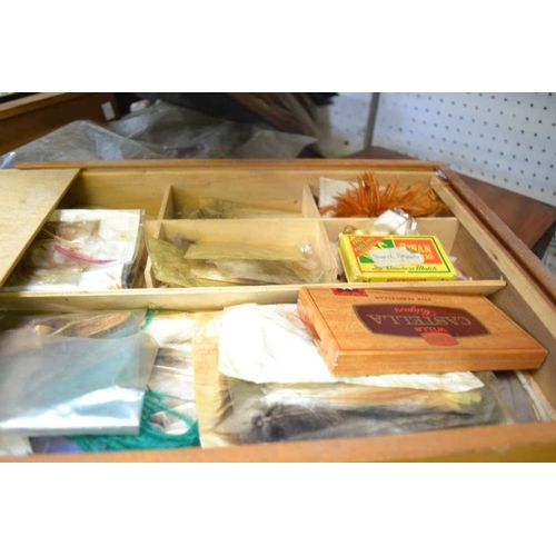 31 - Four assorted wooden fly and tackle boxes with contents, an unhooking net and a file of fly feathers