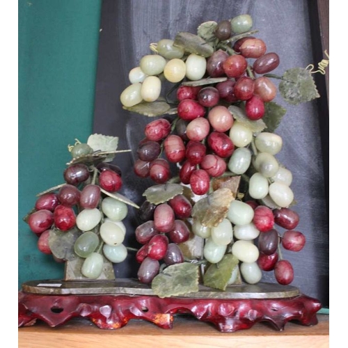 421 - A pair of decorative carved hardstone bunches of grapes