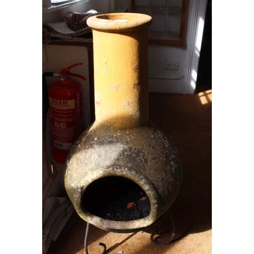 438 - A well weathered terracotta garden chimenea