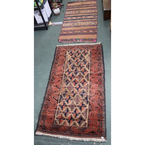 A hand knotted woollen carpet with applied pompoms