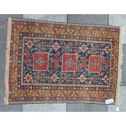 105 - An Afghan Shirvan rug, blue ground with three red central medallions divided by stylized birds and f... 