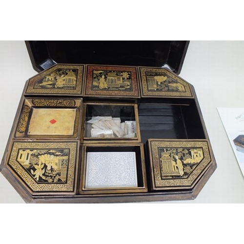 29 - An early 19th century Chinese Canton black lacquer games box with gilded and red border decoration, ... 