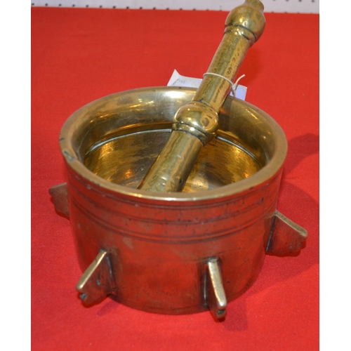 8 - A 17th century style brass mortar spaced with six spines with brass pestle 14.5 cm diam.