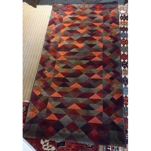 95 - A late 20th century wool covered geometric Harlequin rug, 93cm x 102cm