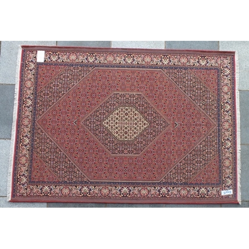 97 - A Persian Bidjar rug, salmon pink ground with central cream medallion, overall stylized floral desig... 